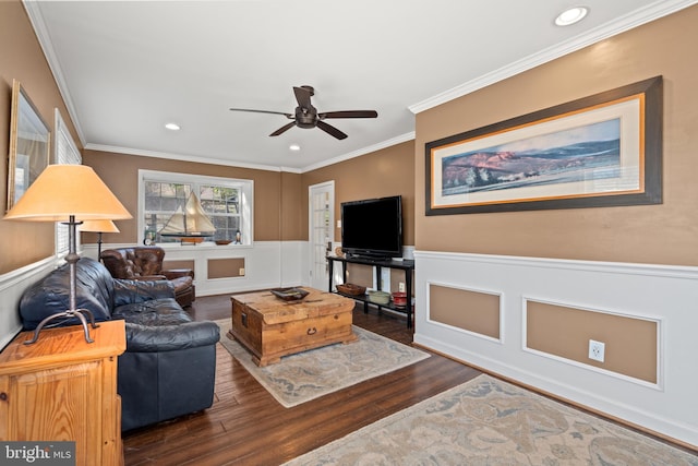 living room with dark wood-type flooring, ceiling fan, and crown molding