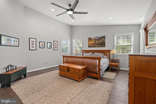 bedroom featuring multiple windows, vaulted ceiling, dark hardwood / wood-style floors, and ceiling fan