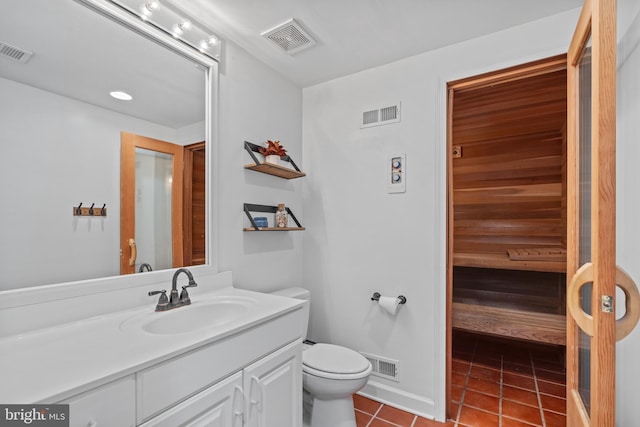 bathroom featuring vanity, toilet, and tile patterned flooring