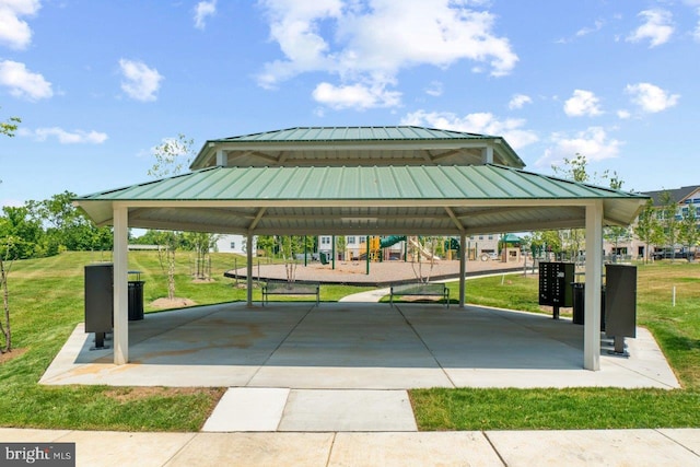 surrounding community featuring a playground, a gazebo, a mail area, and a yard