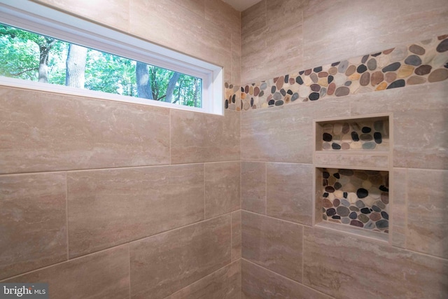 bathroom with a tile shower