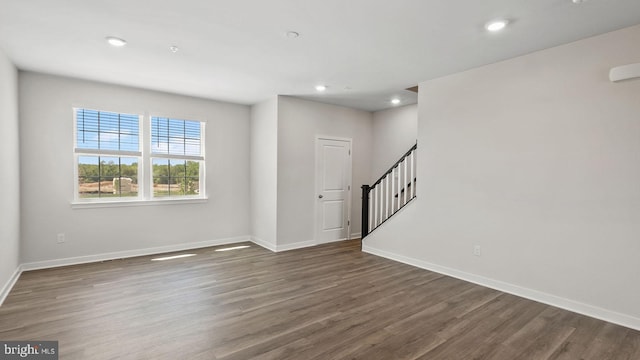 empty room with dark hardwood / wood-style floors