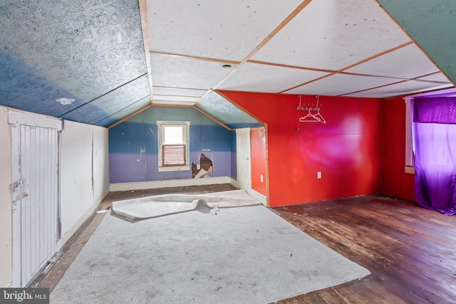 bonus room with hardwood / wood-style flooring and lofted ceiling