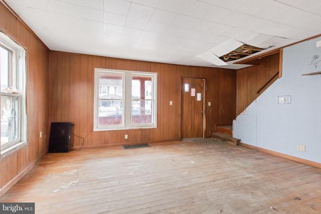 entrance foyer with wood walls and light wood-type flooring