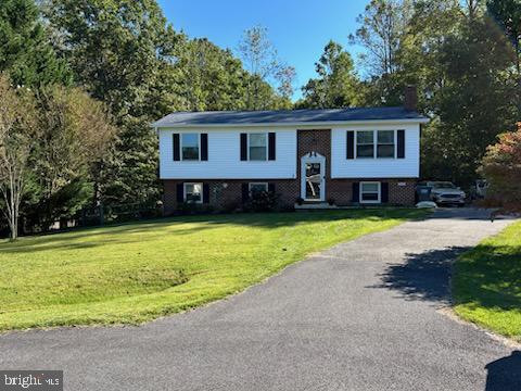 bi-level home with a front lawn