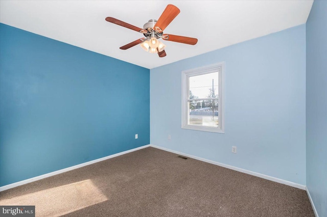 empty room featuring carpet floors and ceiling fan