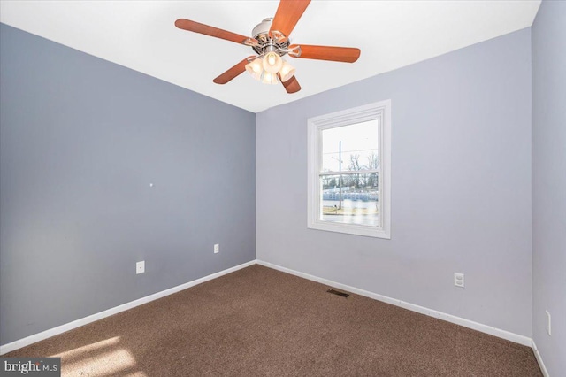 empty room featuring ceiling fan and carpet flooring