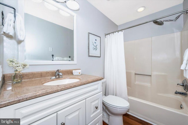 full bathroom featuring shower / tub combo with curtain, vanity, and toilet