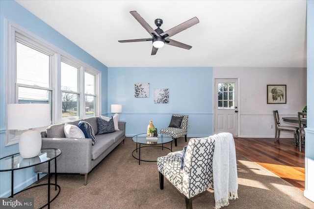 living room with hardwood / wood-style floors, a wealth of natural light, and ceiling fan