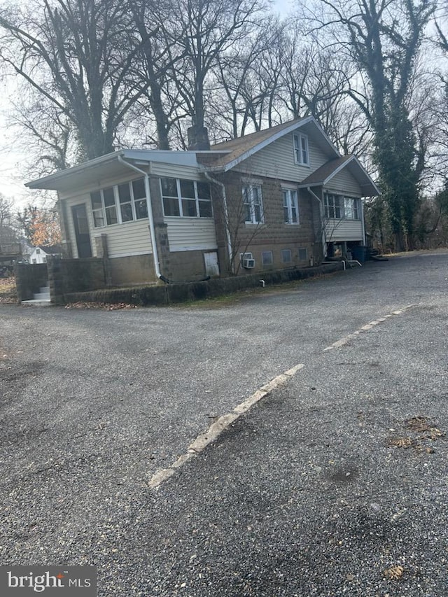 view of front of house with a sunroom