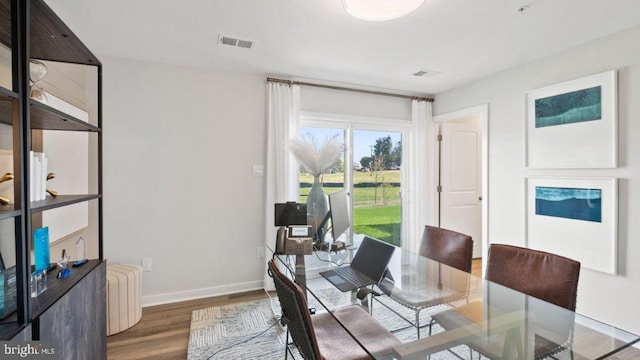 dining space with dark wood-type flooring