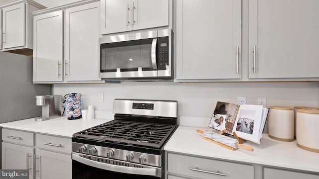 kitchen featuring gray cabinets and appliances with stainless steel finishes