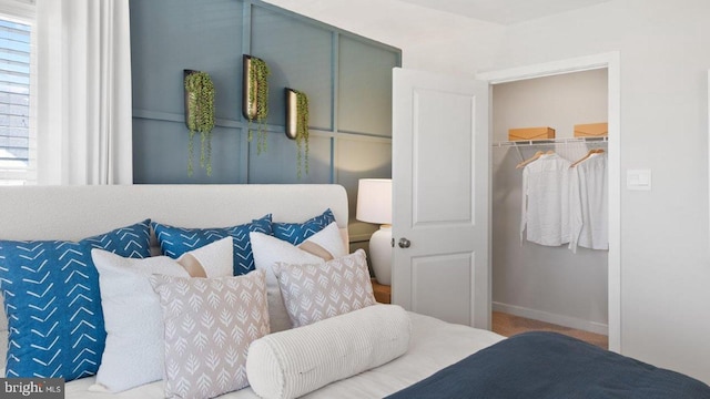 bedroom featuring a spacious closet and a closet