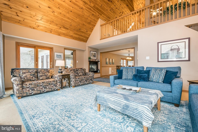 carpeted living room with wooden ceiling and high vaulted ceiling