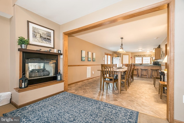 dining area with a multi sided fireplace