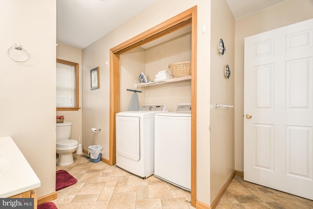 clothes washing area with washer and clothes dryer