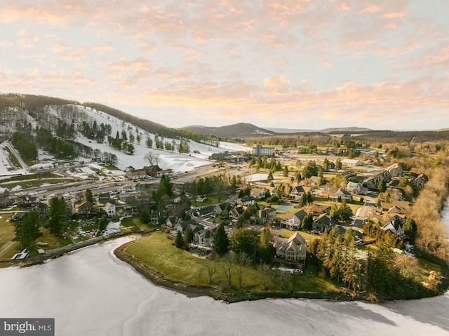 snowy aerial view featuring a mountain view