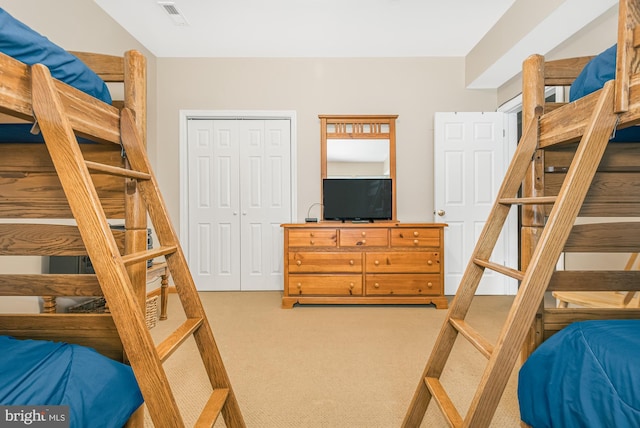 bedroom featuring a closet and carpet flooring