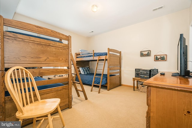 bedroom featuring light carpet