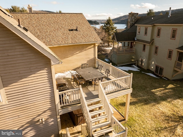 deck featuring a water view and a yard