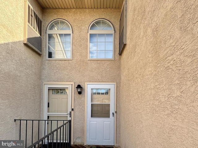 property entrance with stucco siding