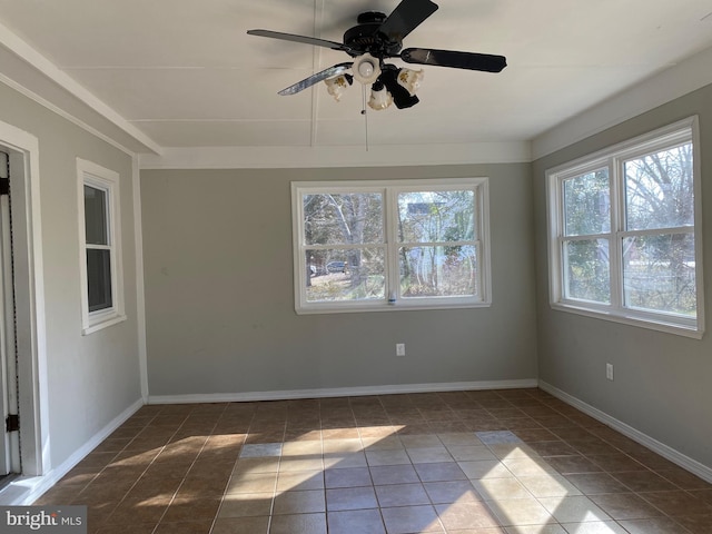 empty room featuring tile patterned floors and baseboards