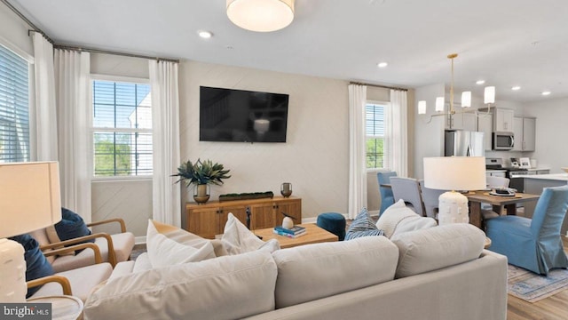 living room with a healthy amount of sunlight and light hardwood / wood-style flooring