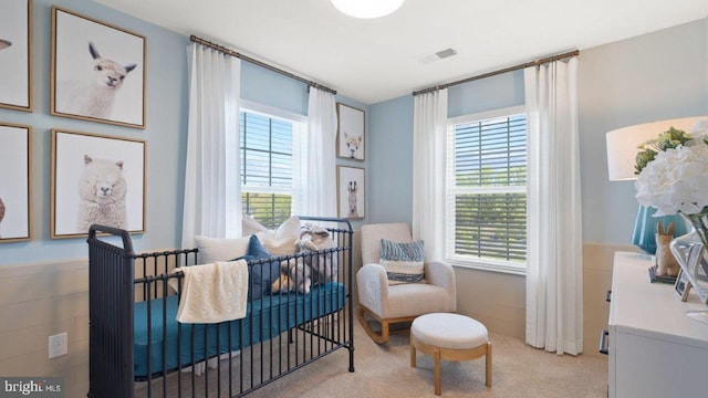 living area featuring plenty of natural light and light carpet