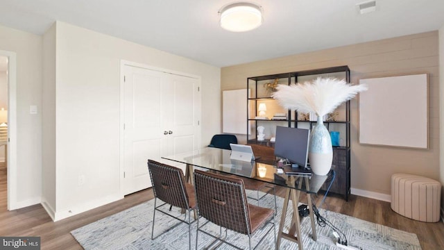 office space with wood-type flooring and radiator heating unit