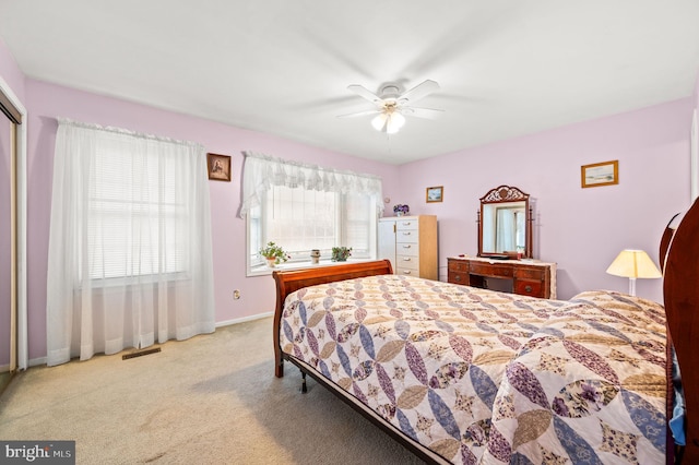 bedroom featuring light carpet and ceiling fan