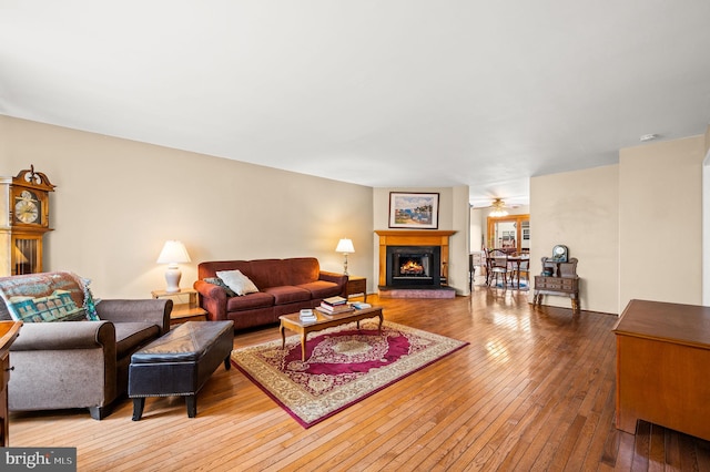 living room with ceiling fan and wood-type flooring