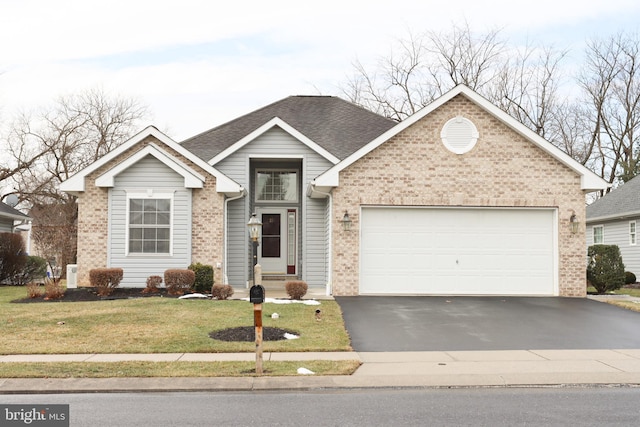 view of front of home featuring a garage and a front lawn