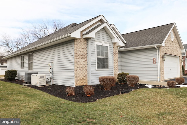 view of property exterior featuring a garage, central AC, and a lawn