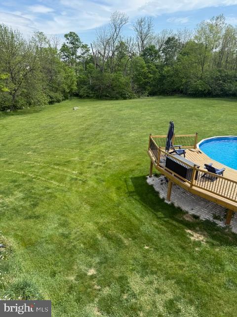 65 Campbell Rd, York, PA 17402 - view of grassy yard with a deck and an outdoor pool