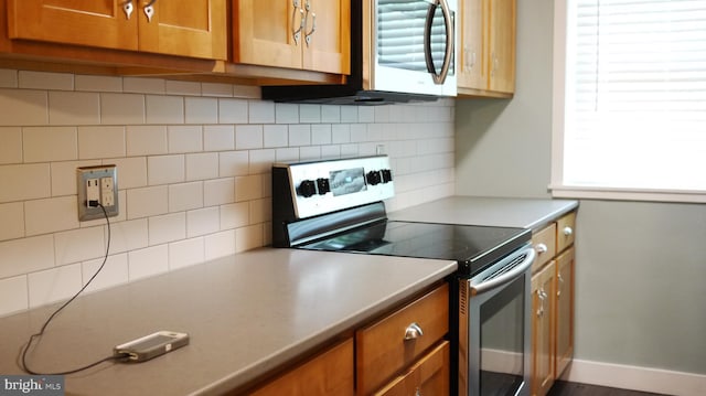 kitchen with stainless steel appliances and backsplash