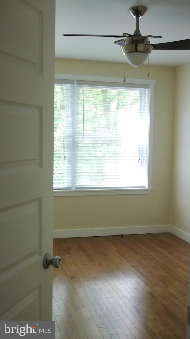 spare room featuring ceiling fan and hardwood / wood-style floors