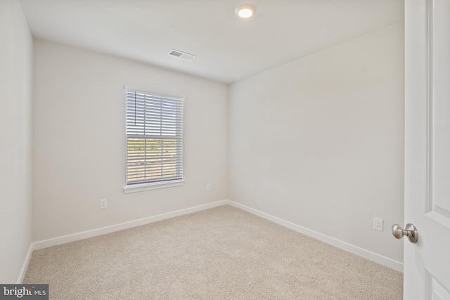 unfurnished room featuring light carpet