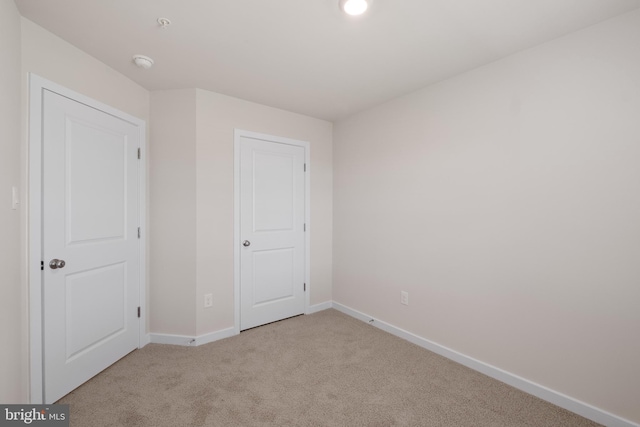 unfurnished bedroom featuring light colored carpet