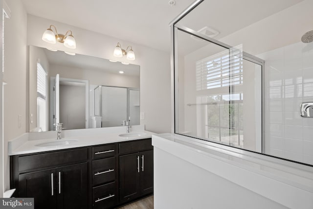 bathroom with vanity, an enclosed shower, and hardwood / wood-style floors