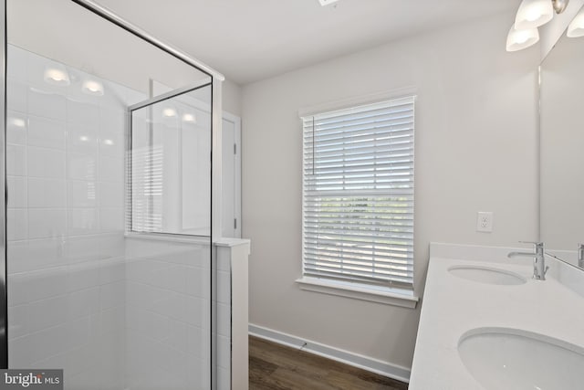 bathroom with vanity, a shower with door, and hardwood / wood-style floors