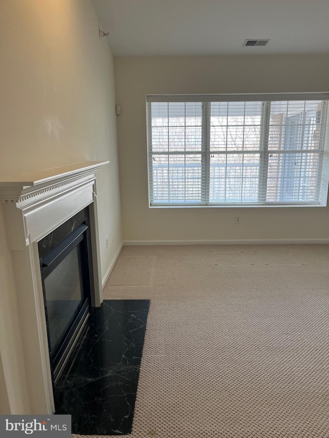 unfurnished living room featuring carpet flooring