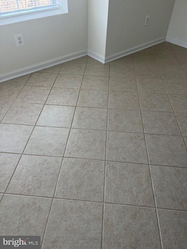 empty room with light tile patterned floors