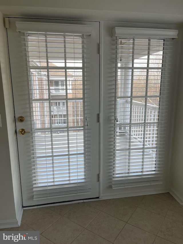 entryway featuring a healthy amount of sunlight and tile patterned flooring