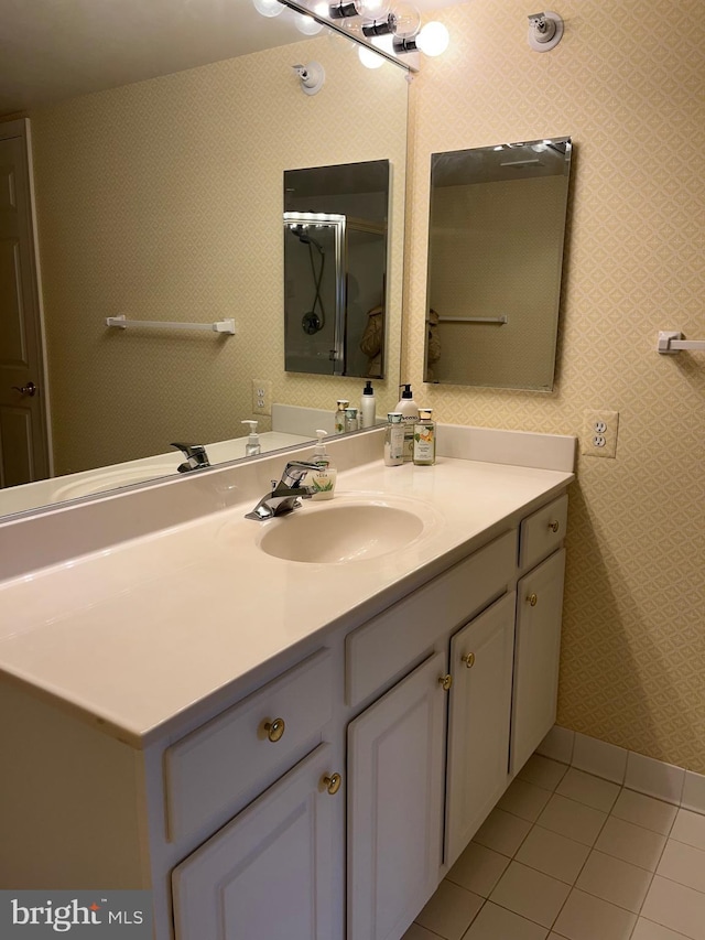 bathroom with tile patterned flooring, vanity, and an enclosed shower