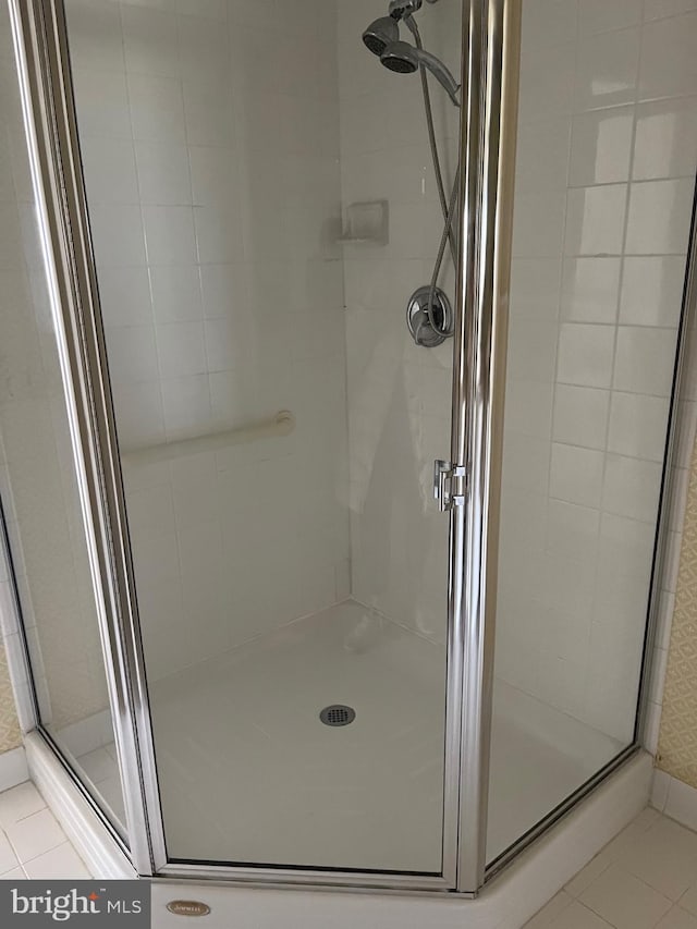 bathroom featuring walk in shower and tile patterned floors