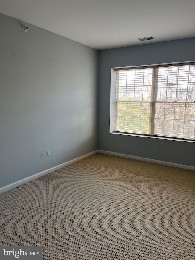 unfurnished room featuring carpet flooring