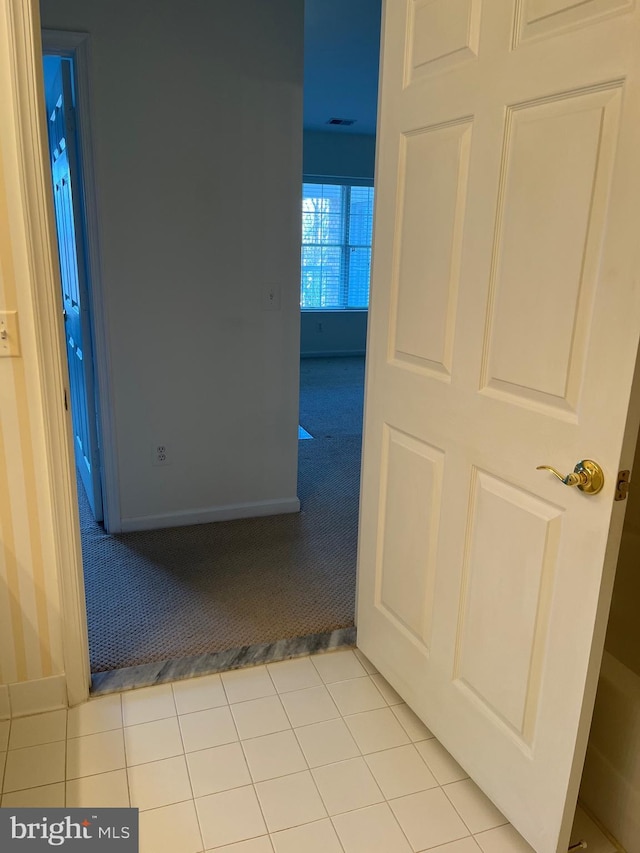 hall with light tile patterned flooring