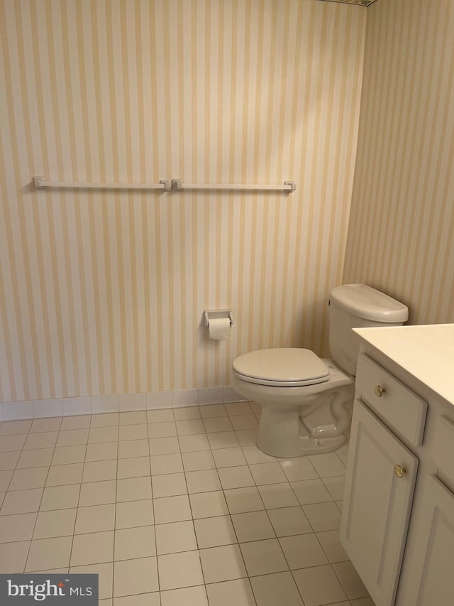 bathroom with vanity, tile patterned floors, and toilet