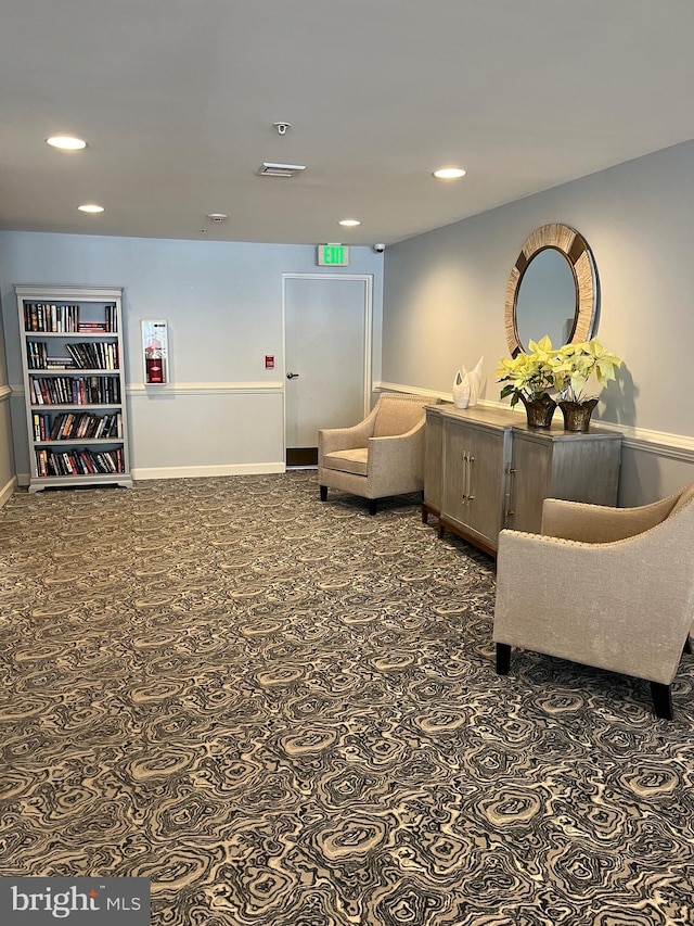 sitting room with dark colored carpet