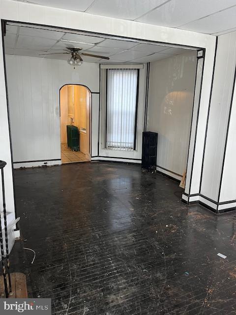 unfurnished living room featuring a paneled ceiling